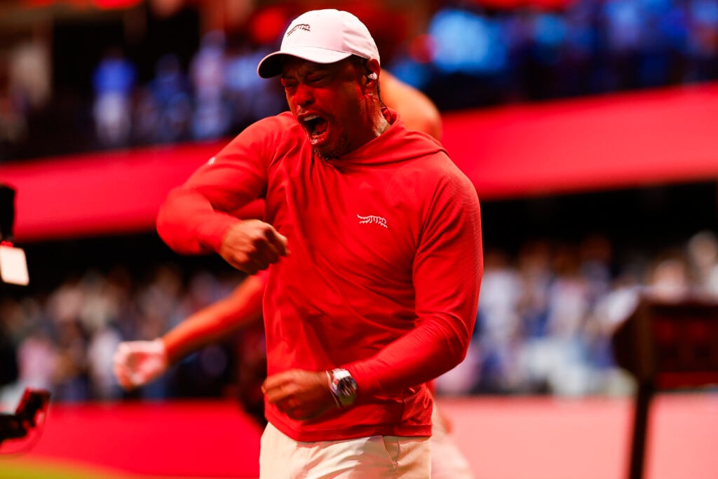 Tiger Woods celebrates Tom Kim making a hole in one during their TGL match