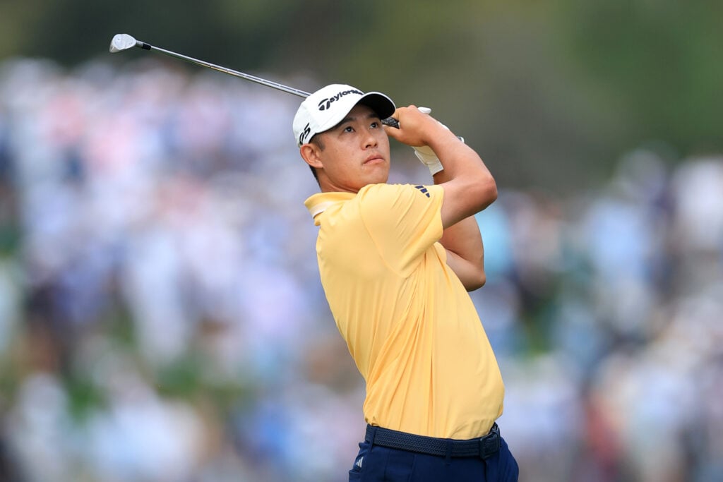 Collin Morikawa watches his approach on the opening hole at The Players Championship