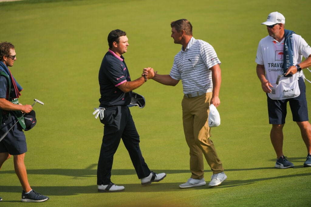 Bryson DeChambeau and Patrick Reed shake hands after the second round of the Travelers Championship