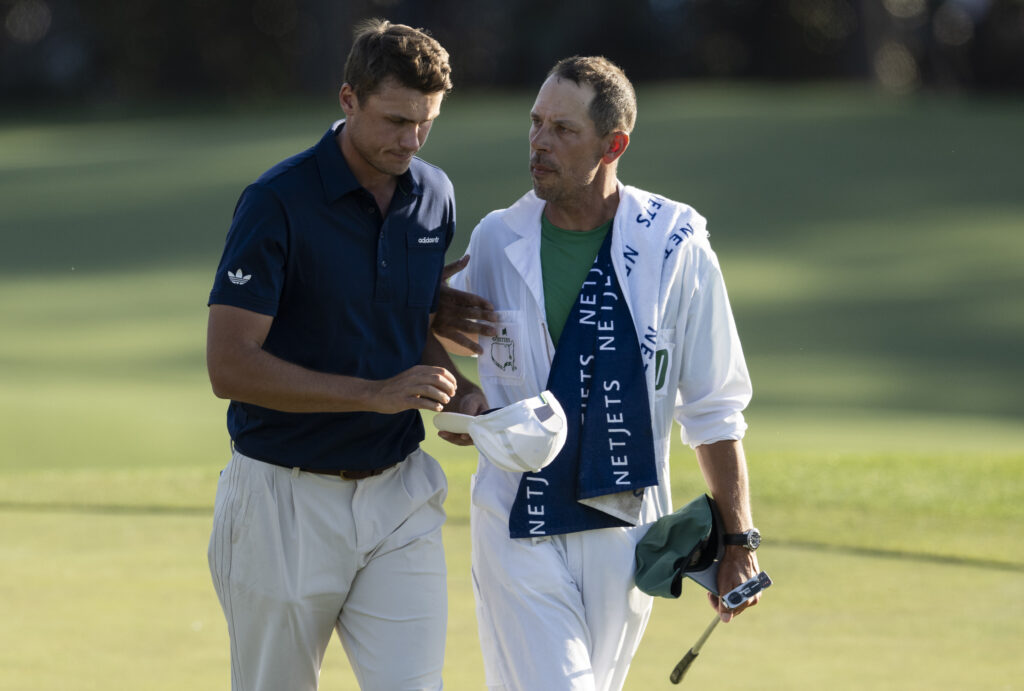 Ludvig Åberg speaks with his caddie after the final round of the 2025 Masters