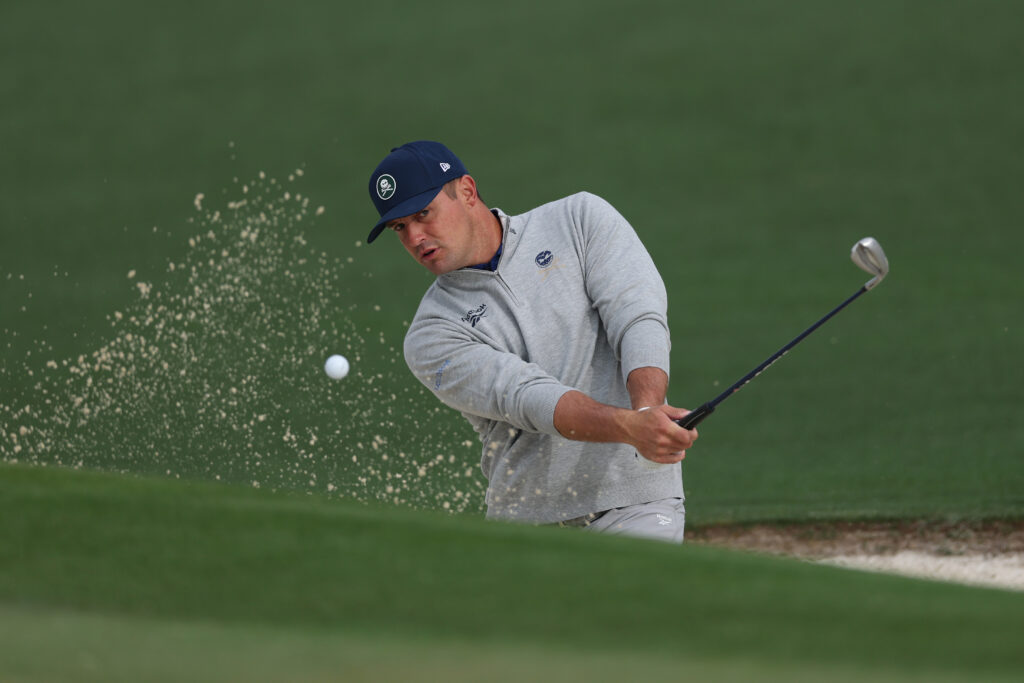 Bryson DeChambeau of the United States hits out of a greenside bunker on the second hole during a practice round prior to the 2026 Masters Tournament at Augusta National Golf Club