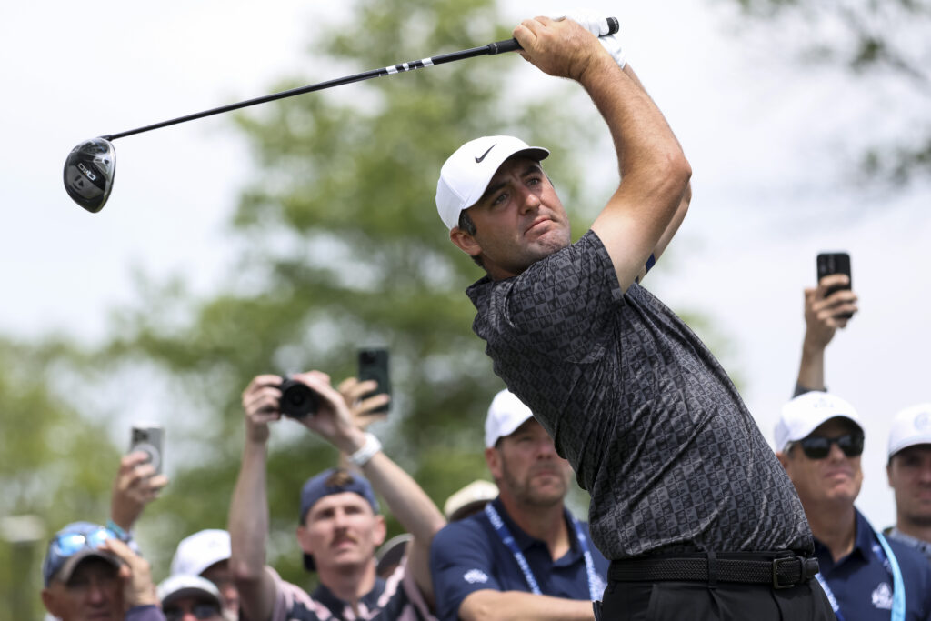 Scottie Scheffler of the United States hits a tee shot on the 12th hole during a practice round prior to the PGA Championship at Aronimink Golf Club