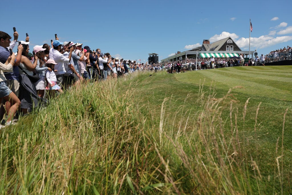 Fans watch as Scottie Scheffler of the United States plays his shot from the first tee during the third round of the 126th U.S. OPEN at Shinnecock Hills Golf Club
