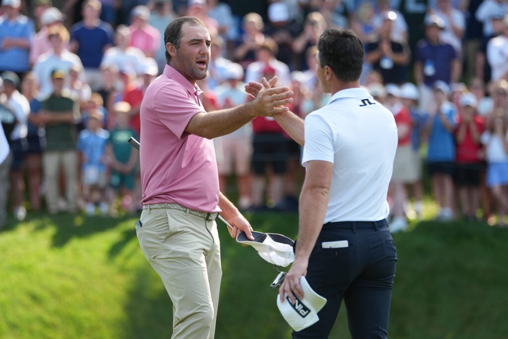 Scottie Scheffler shakes hands with Viktor Hovland after their playoff at the Travelers Championship