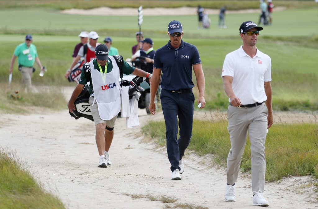 Adam Scott (R) of Australia and Henrik Stenson (2nd R) of Sweden walk to fifth hole during the first round of the 2018 U.S. Open at Shinnecock Hills Golf Club