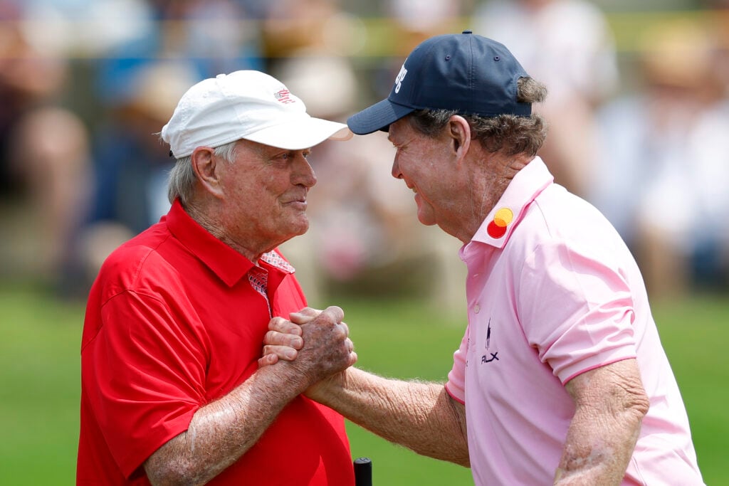 Jack Nicklaus of the United States (L) shakes hands with Tom Watson of the United States on the 18th hole as they participate in the Folds of Honor Greats of Golf