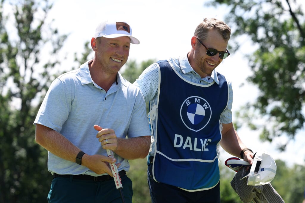 Brad Dalke of the United States reacts with his caddie after finishing his round on the ninth green on day two of the BMW International Open 2026